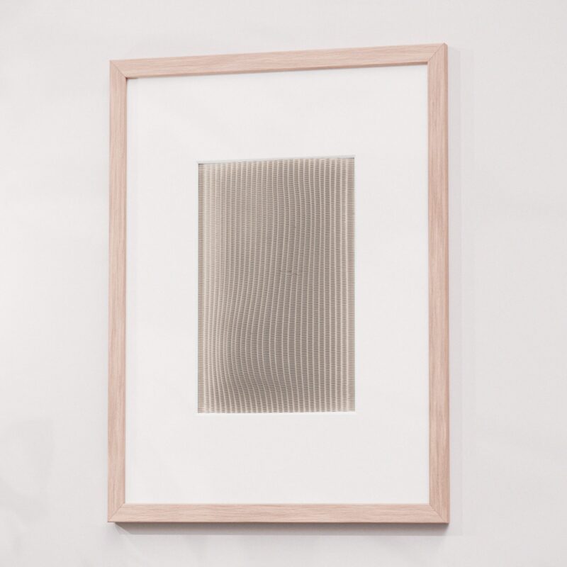 Framed artwork featuring a modern pattern of small abstract triangles, perfect for contemporary decor.